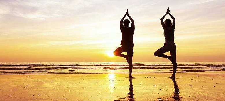 beach yoga couple