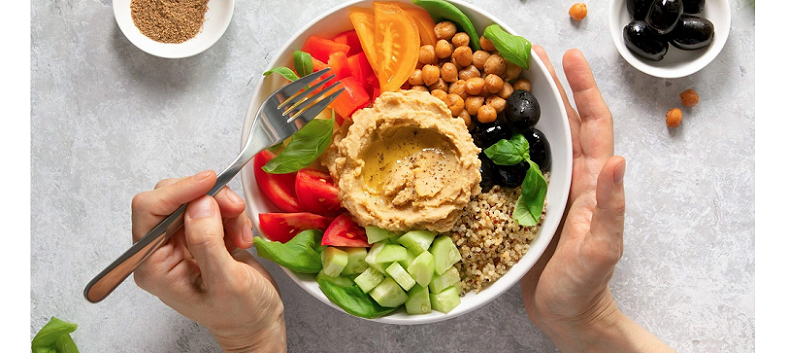 eating mediterranean salad bowl